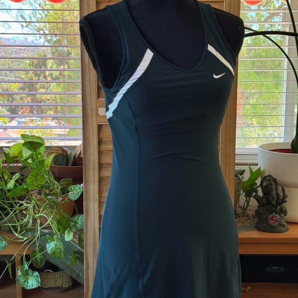 Nike black tank tennis dress with white swoosh, sleeveless V-neck.